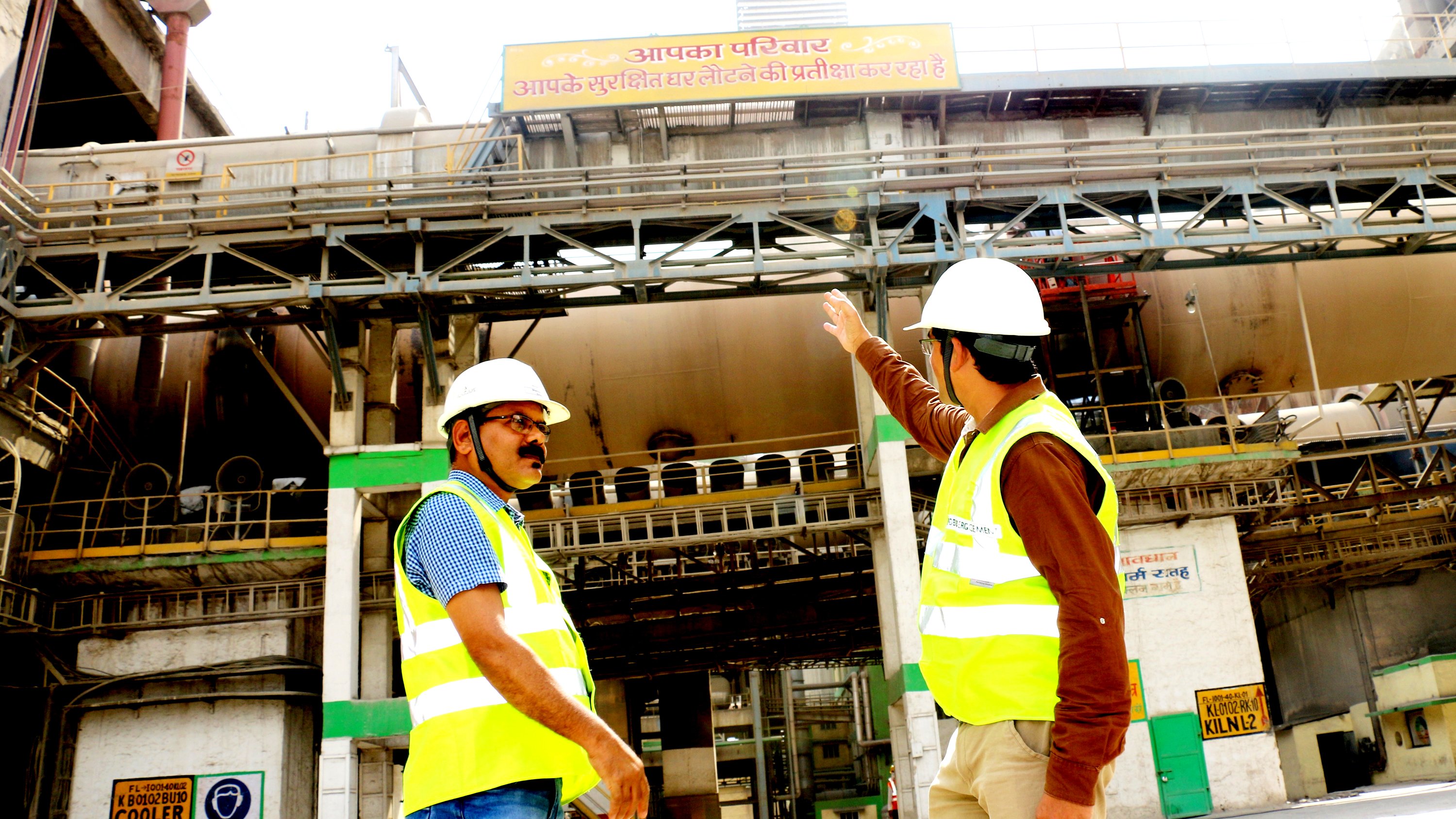 Two indian employees assess a concrete plant