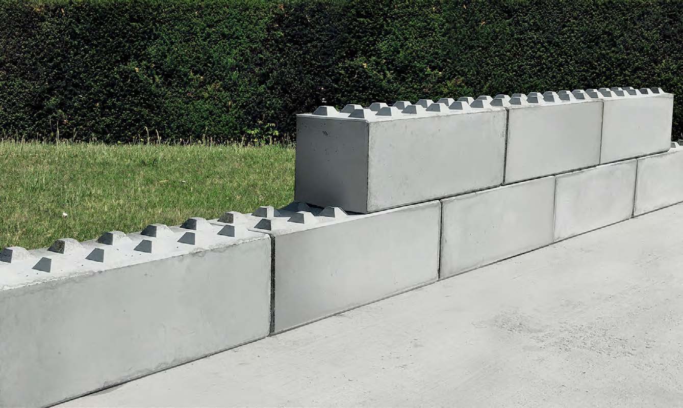 Large stackable concrete blocks form a wall