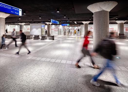 A modern underground metro with concrete pillars