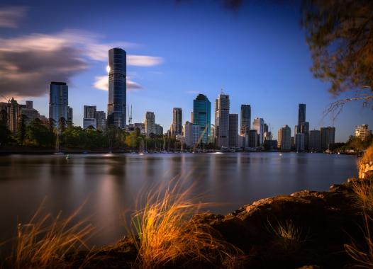 The Brisbane skyline besides a river