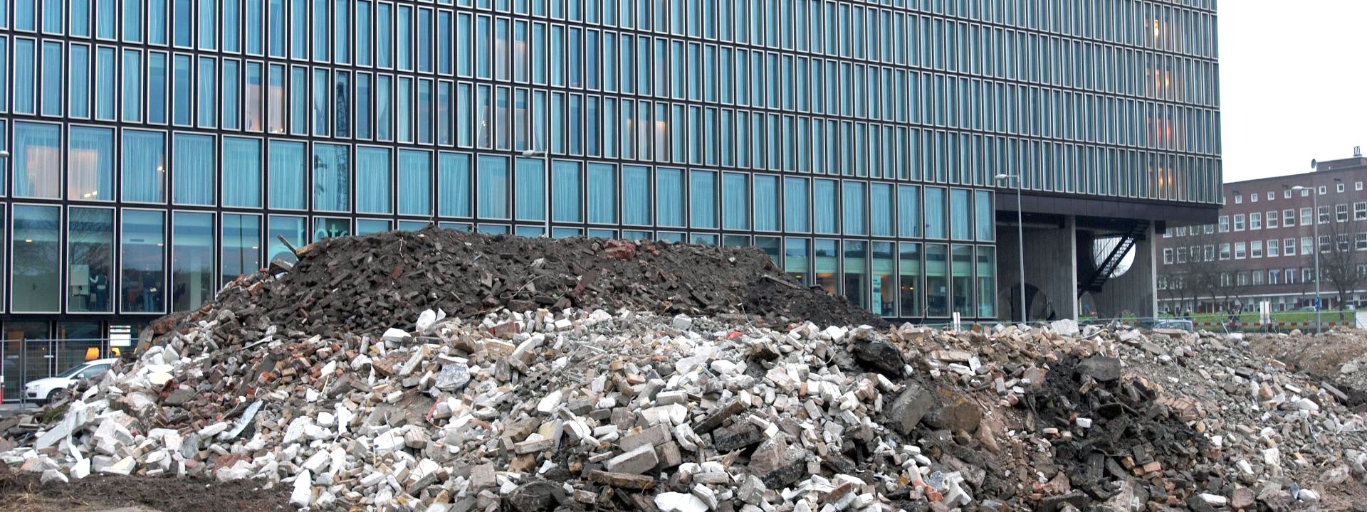 A large pile of rubble in front of a building
