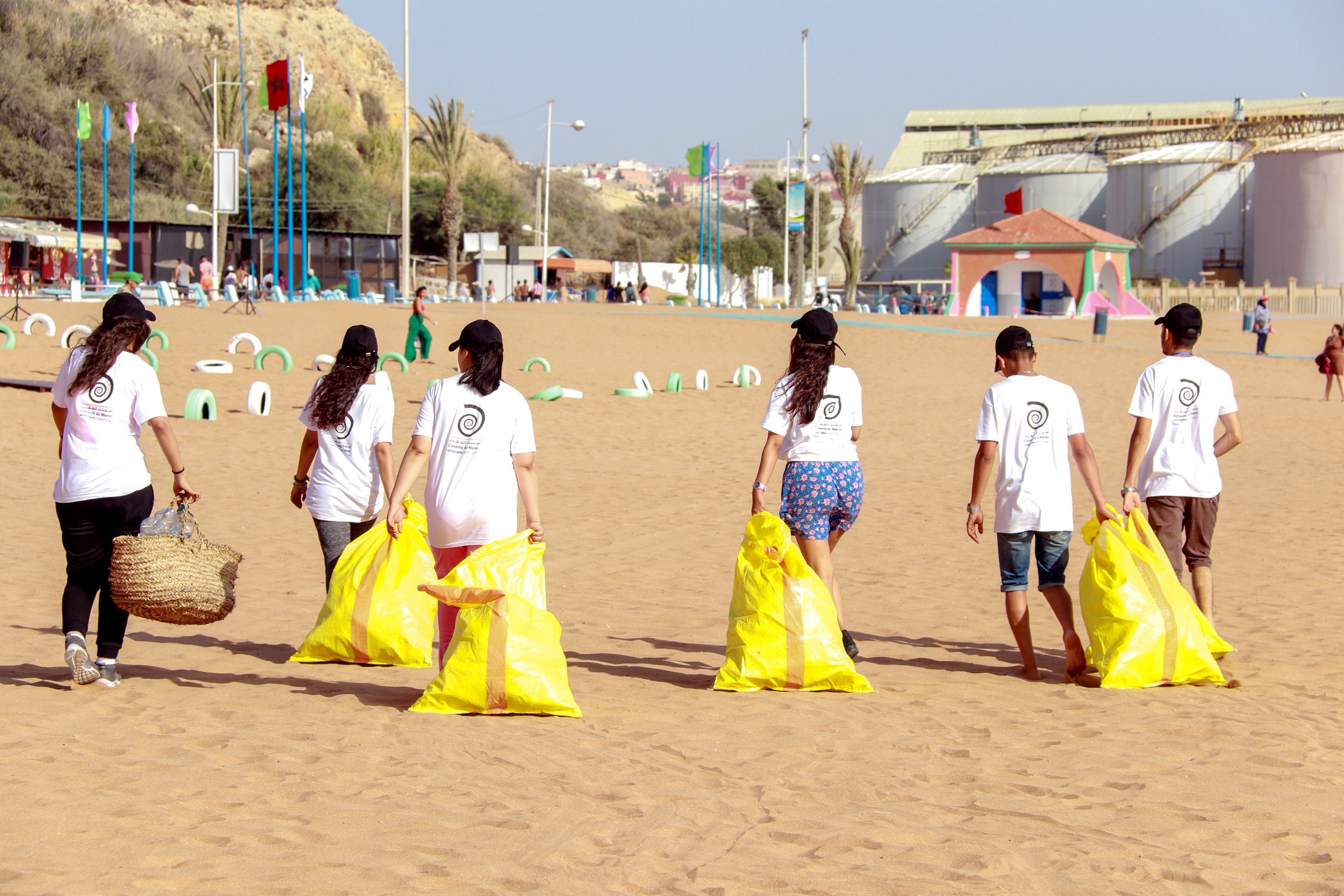 People with yellow bags on the beach