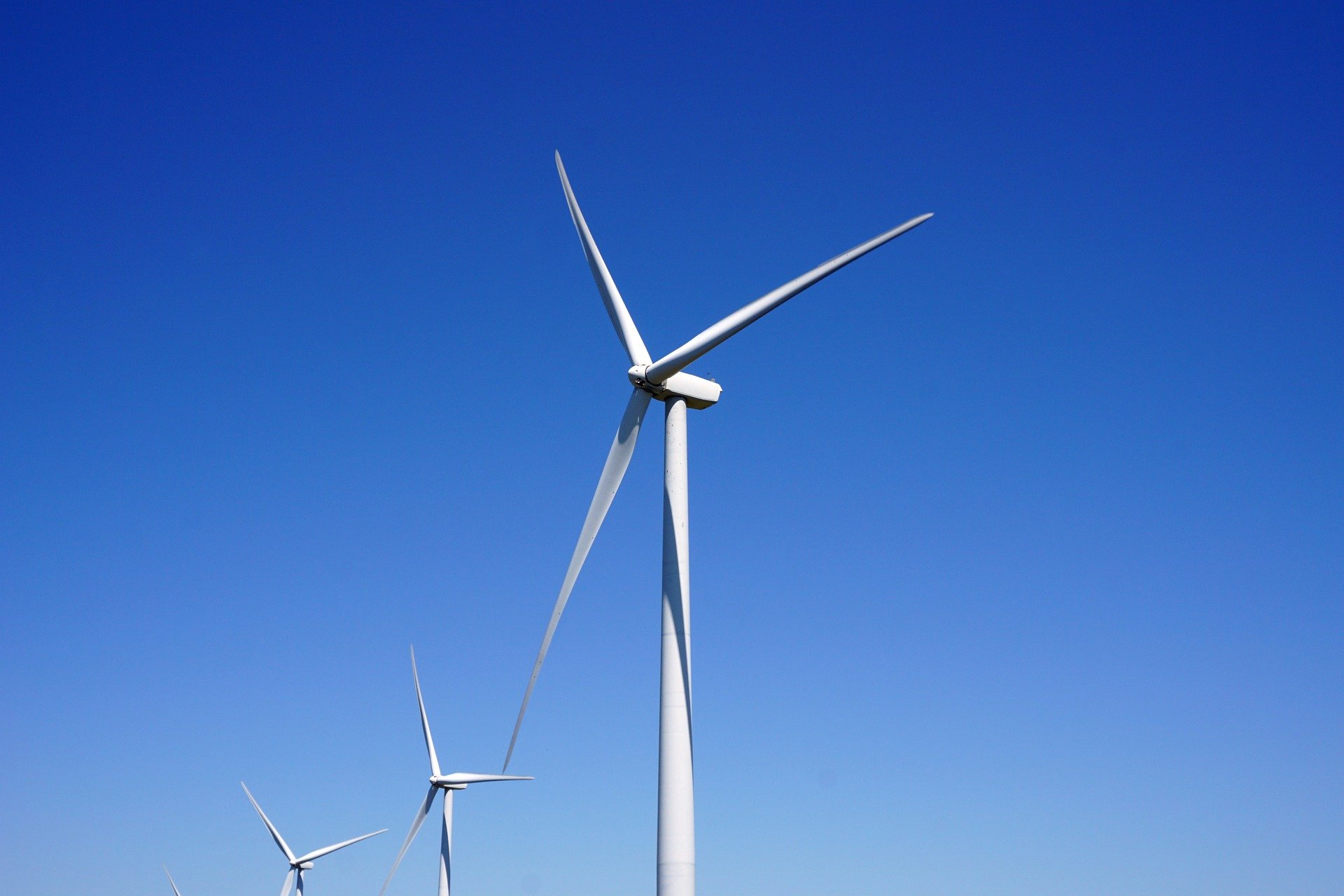 A wind turbine against a blue sky