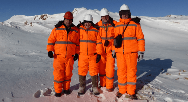 Four men within a snowy landscape.